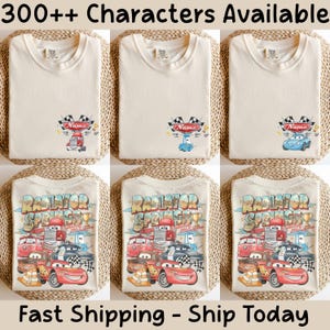 May include: A cream-colored t-shirt featuring a small graphic on the chest with a race car and checkered flags, and a large back graphic displaying multiple animated race cars, the text Radiator Springs, and Lightning McQueen.