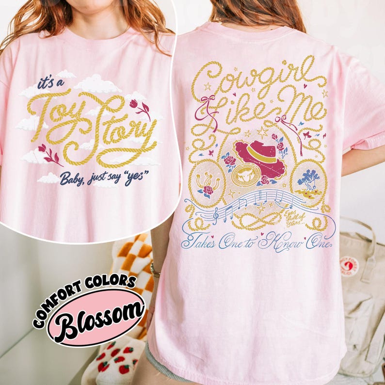 May include: A light pink t-shirt featuring a front graphic with yellow rope-style text reading it's a Toy Story Baby, just say yes and a back graphic with yellow rope text reading Cowgirl like Me and Takes One to Know One with a hat illustration.
