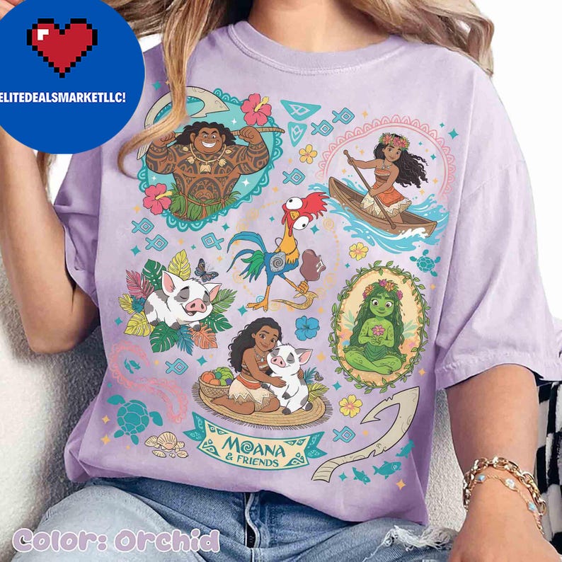 May include: Orchid-colored t-shirt featuring a colorful graphic of characters from the animated film Moana. The design includes illustrations of Maui, Moana, Pua, Hei Hei, and other elements from the movie. The text "Moana & Friends" is also visible.