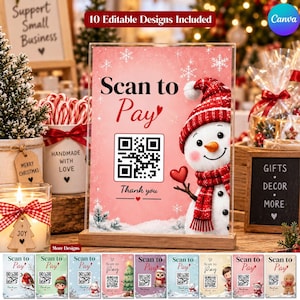 May include: A rectangular acrylic sign with a wooden base featuring a pink background, a snowman wearing a red hat and scarf, a QR code, and the text Scan to Pay and Thank you. The design includes white snowflakes and a small red heart.