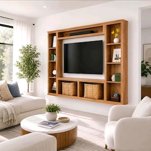 May include: A large, wall-mounted wooden media console featuring a central rectangular space for a television, surrounded by multiple open shelving units. The shelves contain decorative items, books, and two woven baskets for storage.