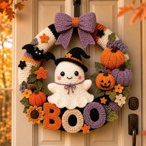 May include: A crocheted Halloween wreath featuring a central white ghost wearing a black witch hat, surrounded by orange and purple pumpkins, green leaves, small flowers, a black bat, and a large purple bow. The word BOO is spelled out in yarn.