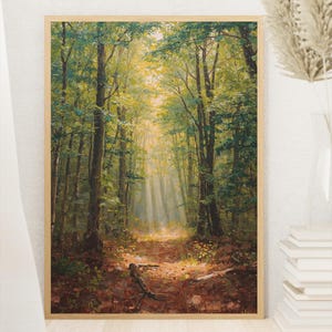 May include: A framed landscape painting of a forest scene. The artwork depicts a path leading into a sunlit clearing, surrounded by tall trees with green foliage. The painting has a warm color palette with brown, green, and yellow hues.
