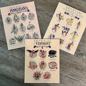 May include: Three tan-colored posters with illustrations of cryptids from Pennsylvania, Rhode Island, and Vermont. Each poster features a title and several drawings of mythical creatures in a vintage style.