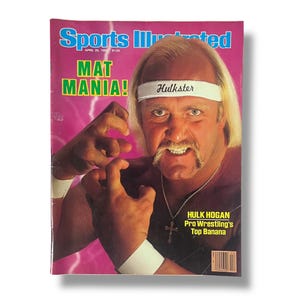 May include: Sports Illustrated magazine cover featuring wrestler Hulk Hogan. The cover has the text "MAT MANIA!" and "Hulkster" on a headband. The magazine is dated April 29, 1985, and includes the text "HULK HOGAN Pro Wrestling's Top Banana."