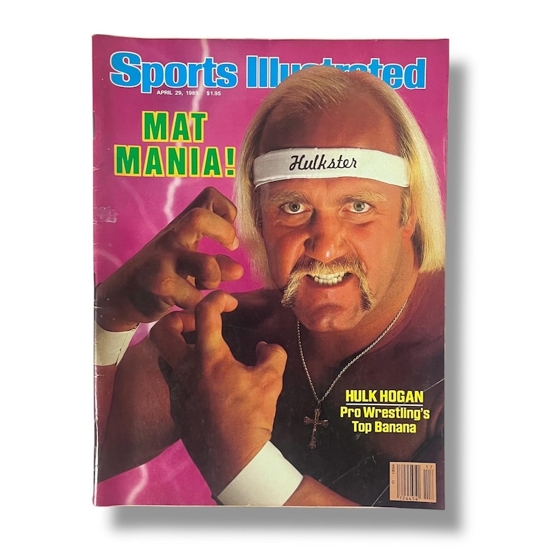 May include: Sports Illustrated magazine cover featuring wrestler Hulk Hogan. The cover has the text "MAT MANIA!" and "Hulkster" on a headband. The magazine is dated April 29, 1985, and includes the text "HULK HOGAN Pro Wrestling's Top Banana."