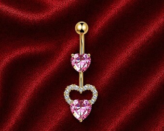 Piercing para ombligo con forma de corazón dorado y colgante de cristal rosa.