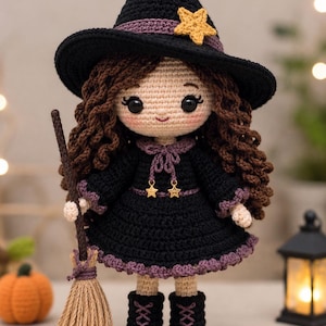 May include: A crocheted doll dressed as a witch, featuring a black pointed hat with a yellow star, long brown curly hair, and a black dress with purple trim. The doll holds a small broom and wears black boots with purple laces and star charms.