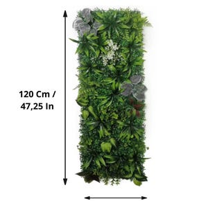 May include: Rectangular artificial plant wall, 47.25 inches tall and 15.75 inches wide, featuring a variety of green foliage and some gray and white accents. The wall is densely packed with different types of leaves and plants.
