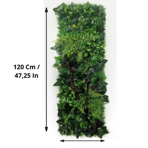 May include: A rectangular artificial green wall, 47.25 inches tall and 15.75 inches wide, featuring a variety of faux foliage. The design includes ferns, ivy, and other greenery, with a dark brown branch accent. Ideal for interior decor.