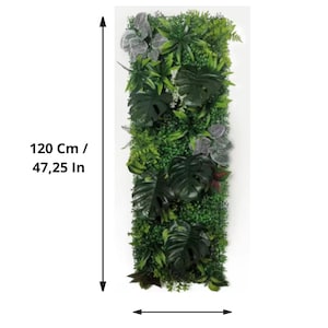 May include: Vertical artificial plant wall panel, 47.25 inches tall and 15.75 inches wide, featuring a variety of green foliage. The panel includes large, dark green monstera leaves and smaller, textured plants.
