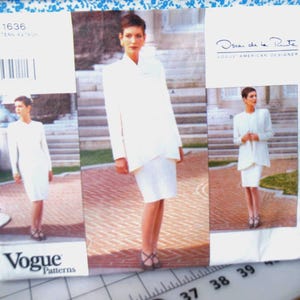 May include: Vogue Patterns sewing pattern featuring a white suit designed by Oscar de la Renta. The pattern includes a jacket and skirt, with the model wearing the outfit in three different poses. The pattern number is 1636.