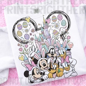 May include: White sweatshirt featuring a colorful graphic of Disney characters dressed as Easter bunnies in front of a castle. The design includes Mickey, Minnie, Donald, Daisy, Goofy, and Pluto, with Easter eggs and flowers.