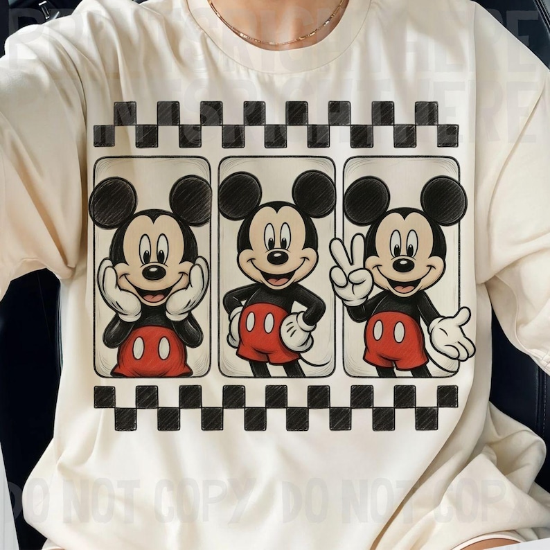 May include: Cream-colored t-shirt featuring a graphic of Mickey Mouse in three different poses. Mickey is wearing red shorts, white gloves, and black shoes. The design is framed by a black and white checkered pattern.