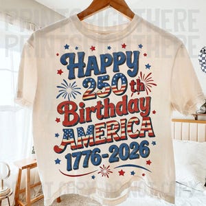 May include: Cream-colored t-shirt with a patriotic design celebrating America's 250th birthday. The design features the words "Happy 250th Birthday AMERICA 1776-2026" in red, white, and blue, with star and firework accents.