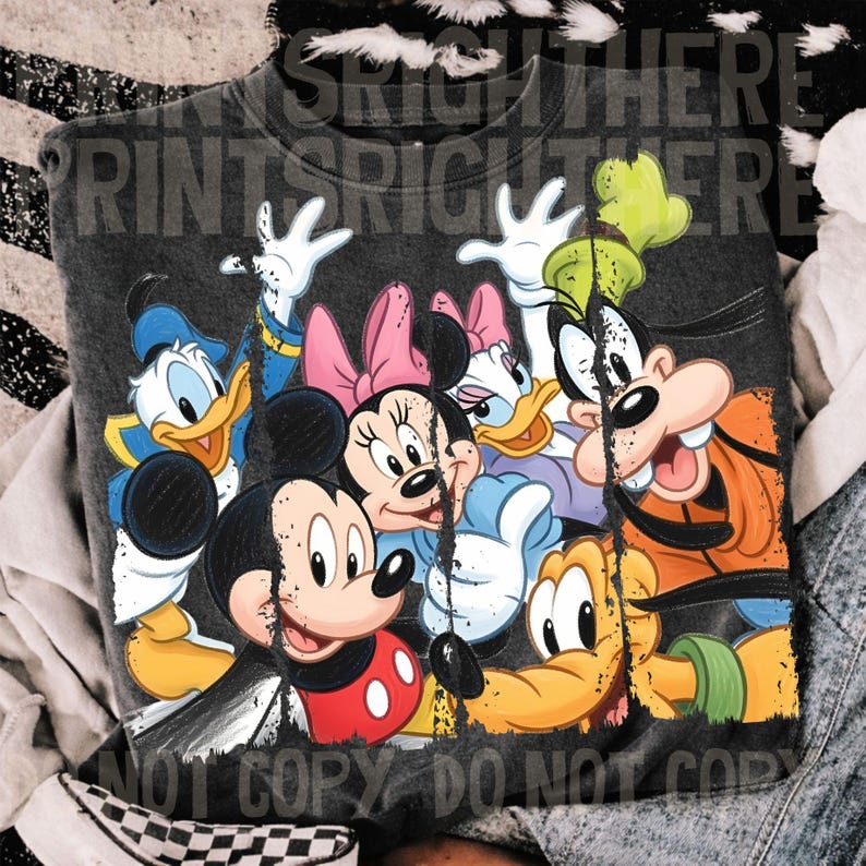 May include: Dark gray sweatshirt featuring a colorful graphic of Mickey Mouse, Minnie Mouse, Donald Duck, Daisy Duck, Goofy, and Pluto. The design has a distressed, vintage look. The text "PRINTS RIGHT THERE" and "NOT COPY DO NOT COPY" are visible.