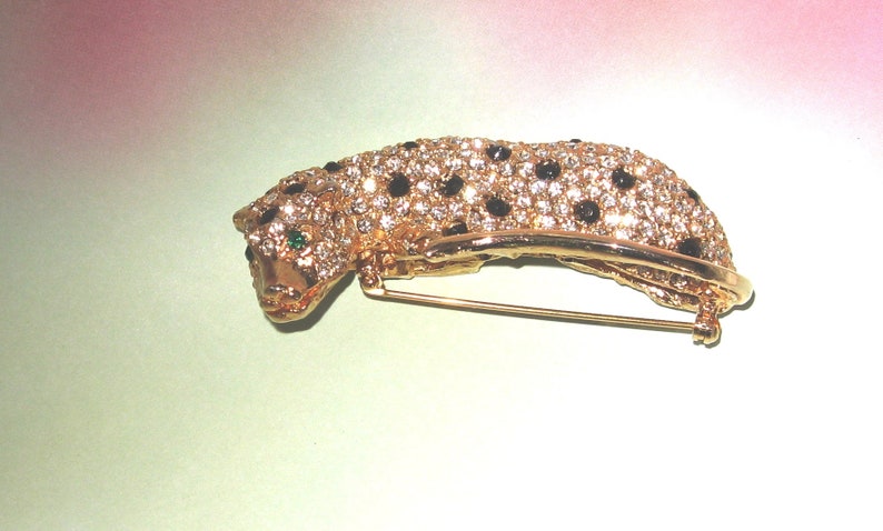 AVON Kenneth Lane Panther Brooch Pin KJL AVON Book Piece Three dementional with green eyes black stones and lots of pave clear crystals