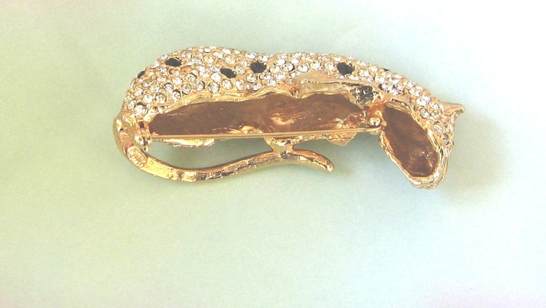 AVON Kenneth Lane Panther Brooch Pin KJL AVON Book Piece Three dementional with green eyes black stones and lots of pave clear crystals