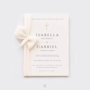 May include: A cream-colored wedding invitation card featuring a gold cross icon, black serif typography, and a tied off-white fabric ribbon on the left side. The text reads Isabella Rose Bennett and Gabriel Thomas Laurent, September 26, 2027.