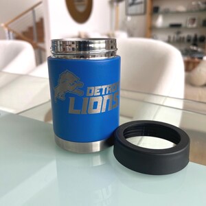Show your football pride and keep your favorite drink ice cold with this Detroit Lions-inspired 12 oz insulated bottle cooler. Featuring a laser-engraved design on a durable, powder-coated blue finish, it combines style, function, and team spirit in one premium game day accessory. The double-wall stainless steel insulation keeps drinks at the perfect temperature longer, making it ideal for tailgates, backyard barbecues, camping trips, man caves, or just relaxing while watching the big game.