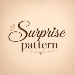 May include: The text "Surprise pattern" is written in a dark brown, elegant script and serif font. The word "Surprise" features a small heart above the letter "i" and decorative flourishes on the left. A curved line with petal accents sits below.
