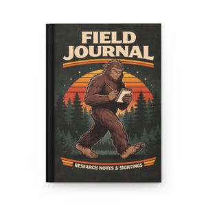 May include: Black hardcover field journal with a retro design. The cover features a brown Bigfoot illustration holding a notepad and pencil, with the words "FIELD JOURNAL" above and "RESEARCH NOTES & SIGHTINGS" below. The background includes a sunset and trees.