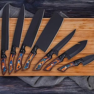 May include: A set of seven kitchen knives with matte black blades and handles featuring a swirling pattern of blue, orange, and brown wood grain. The knives are arranged on a rectangular bamboo cutting board next to a sharpening steel rod.