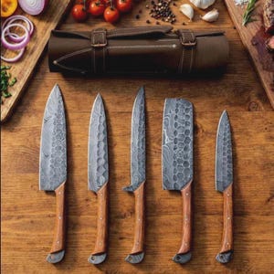 May include: A set of five kitchen knives with patterned Damascus steel blades and wooden handles, arranged in a row. Above the knives sits a brown leather roll-up storage case with two buckled straps, designed for holding and protecting the blades.