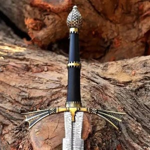 May include: A sword featuring a patterned Damascus steel blade, a black cylindrical grip, and a brass crossguard with decorative flared ends. The pommel is shaped like a textured, metallic dome, and brass accents separate the grip sections.