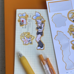 May include: A collection of stickers featuring anime-style characters with blue bows and yellow hair. The stickers are on a notebook with the words "DAILY SCHEDULE" and a yellow pen. The stickers are in various poses.