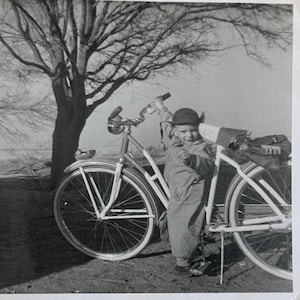 Snap Shot Photo of Toddler and Big Bicycle