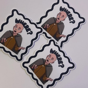 May include: Three stickers featuring a cartoon character with a surprised expression and the word "WHERE?" in a speech bubble. The character is wearing a brown tunic and gray cape, set against a white background with a black wavy border.