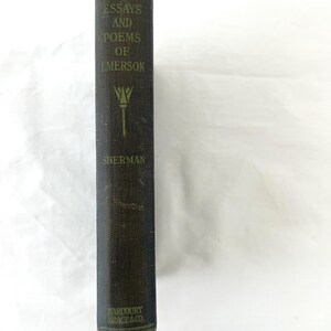 May include: A black hardcover book with gold lettering. The title is "Essays and Poems of Emerson" by Sherman. The book is published by Harcourt, Brace & Co.