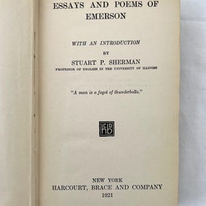 May include: A vintage book cover with the title "Essays and Poems of Emerson" by Stuart P. Sherman, Professor of English in the University of Illinois. The book was published in 1921 by Harcourt, Brace and Company in New York.
