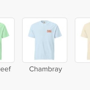 May include: Five short-sleeved t-shirts in various colors: butter, island reef, chambray, ivory, and white. Each shirt has a small, red logo on the upper left chest. The shirts are displayed on a white background.