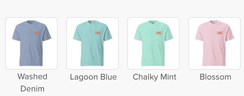 May include: Four short-sleeved t-shirts in different colors: Washed Denim, Lagoon Blue, Chalky Mint, and Blossom. Each shirt has a small, rectangular design on the upper left chest. The shirts are displayed on a white background.