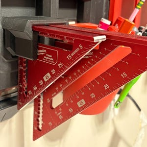 May include: A white ceramic mug with a black handle and the text "But First, Coffee" in a bold, black font. The mug is set against a neutral background, highlighting its simple design.