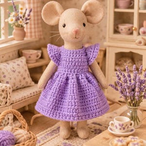 May include: A handmade plush mouse doll wearing a purple crochet dress with ruffled sleeves. The doll has large, round ears and a sweet expression. The scene includes miniature furniture and decor, such as a rug, table, and cabinet.