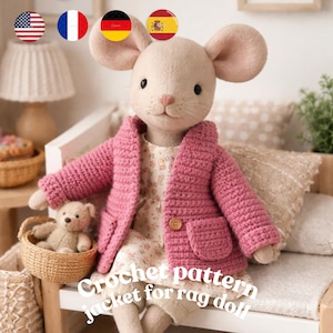 May include: A plush mouse doll wearing a pink crochet jacket with a single button closure and two front pockets. The doll is seated on a white bench with a small teddy bear in a woven basket. Text on the image reads "Crochet pattern jacket for rag doll."