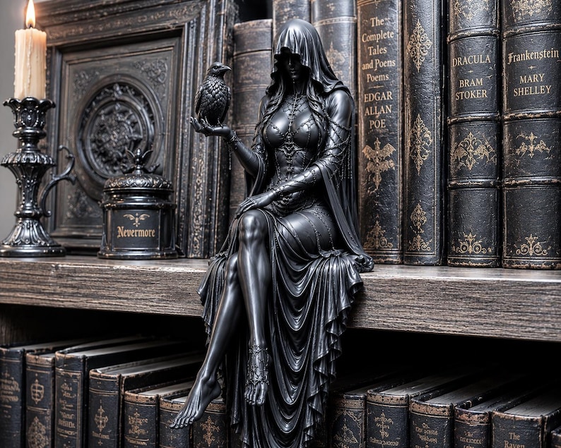 May include: A black figurine of a hooded figure in a long dress sitting on a shelf, holding a raven in one hand. The figure features intricate bodice detailing and a draped skirt. Beside the figure is a black candle holder with a lit candle.