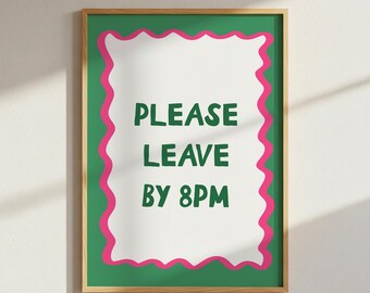 May include: A framed poster with a green background and a white center. The white center has a pink wavy border and the words "PLEASE LEAVE BY 8PM" in green. The frame is a light brown color.