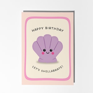 May include: A birthday greeting card with a light pink border and a cream-colored interior. The card features a smiling purple seashell with the words "Happy Birthday" and "Let's shellabrate!" in black text.