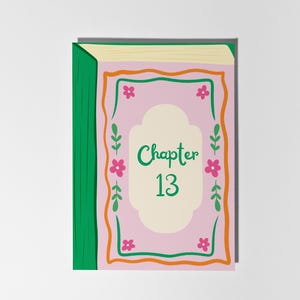 May include: A book illustration with a pink cover featuring the text "Chapter 13" in green. The cover is framed with orange and green lines, pink flowers, and green leaves. The spine is green, and the pages are beige.