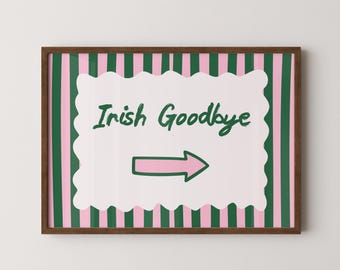 May include: A framed art print with a brown wooden frame. The artwork features a white scalloped shape with the words "Irish Goodbye" in green script and a pink arrow. The background has green and pink vertical stripes.