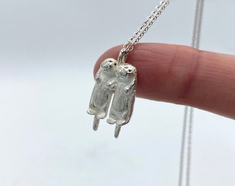 Silver Otters Holding Hands Necklace