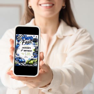 May include: A smartphone screen displaying a digital birthday invitation with the text TWO FAST, JACKSON'S 2ND BIRTHDAY. The design features blue and green race cars, checkered flags, tire tracks, and a speedometer graphic on a white background.