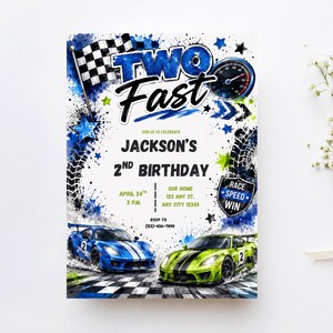 May include: A rectangular birthday invitation card featuring a race car theme with blue and green sports cars, a checkered flag, a speedometer, and tire tracks. The text reads TWO FAST, JACKSON'S 2ND BIRTHDAY, APRIL 24TH, 3 P.M., OUR HOME, 123 ANY ST., ANY CITY 12345, RSVP TO (123)-456-7890, and RACE SPEED WIN.