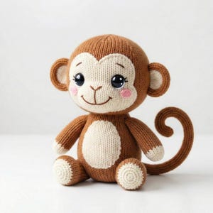May include: A brown and cream-colored knitted monkey doll with a smiling face, rosy cheeks, and large black eyes. The monkey has a curly tail and is sitting upright. The doll is made of soft yarn and is a handmade item.