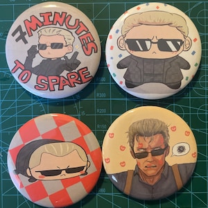 May include: Four circular pin-back buttons featuring anime-style illustrations of a blonde character wearing black sunglasses. One button includes the text 7 MINUTES TO SPARE. The designs show the character in various poses and outfits against backgrounds of white, confetti, red and white checkered patterns, and a light orange field with small red heart icons.