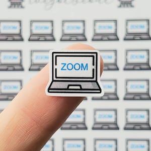 May include: A white laptop sticker with a black outline and the word "ZOOM" in blue text on the screen.